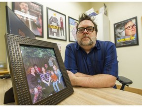 Glen Hoos with portrait of his family in Burnaby.