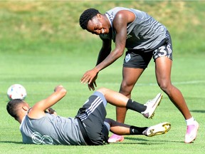 Javain Brown (standing) and Caio Alexandre joke around during Whitecaps training last season. Brown not only impressed with the Whitecaps, earning a new contract in the off-season, but has made an impact at the international level with Jamaica in World Cup qualifying.
