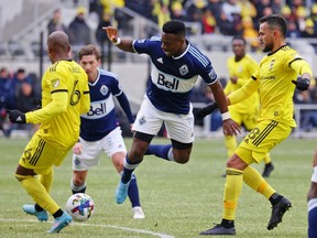 Feb 26, 2022; Columbus, OH, USA; Vancouver Whitecaps forward Cristian Dajome (11) loses control of the ball the ball against Columbus Crew midfielder Darlington Nagbe (6) during the first half at Lower.com Field. Mandatory Credit: Trevor Ruszkowski-USA TODAY Sports