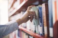 Searching books on the bookshelf at a library.