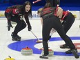 Canada skip Kerri Einarson shouts instructions in the rings as second Shannon Birchard and lead Briane Meilleur brush the stone into the house during a World Women's Curling Championship qualification game against Denmark in Prince George, B.C., Saturday, March 26, 2022.