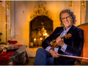 0324 Andre Rieu reclines with one of his vintage instruments.