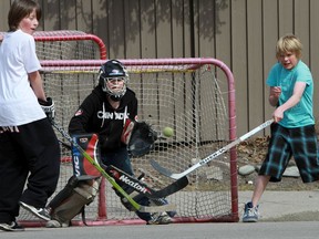 File photo of kids playing street hockey in Calgary.