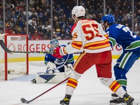 Calgary Flames defenceman Noah Hanifin scores against Vancouver Canucks goalie Thatcher Demko  in the first period at Rogers Arena March 19.