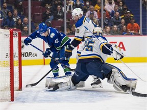 St. Louis Blues defenceman Marco Scandella (6) looks on as goalie Ville Husso (35) makes a save on a shot by Vancouver Canucks forward Elias Pettersson (40) in the first period at Rogers Arena.