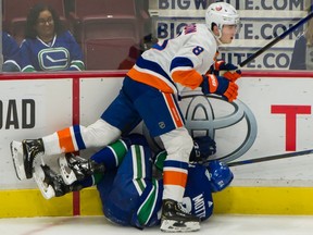Islanders blueliner Noah Dobson, here running over Canucks winger Tyler Motte in a March 2020 Rogers Arena game, has registered 21 points over a 30-game span to share the league lead for most points by a defenceman since Dec. 5.