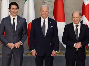 Justin Trudeau, U.S. President Joe Biden and German Chancellor Olaf Scholz pose during the G7 summit in Brussels.