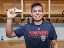 After making this NHL debut, Brady Keeper #25 of the Florida Panthers poses with the game puck after a game against the Ottawa Senators at Canadian Tire Centre on March 28, 2019 in Ottawa, Ontario, Canada.