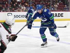 Bo Horvat #53 of the Vancouver Canucks winces while skating to the bench after getting hit in the ankle with the puck during their NHL game at Rogers Arena April 14, 2022.