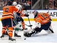 EDMONTON, AB - APRIL 29: Goaltender Mikko Koskinen #19 of the Edmonton Oilers makes a save against Matthew Highmore #15 of the Vancouver Canucks during the first period at Rogers Place on April 29, 2022 in Edmonton, Canada.