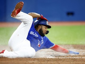 Blue Jays' Vladimir Guerrero Jr. slides into home to score a run in the fourth inning against the Boston Red Sox.