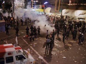 Police try to quell the rioters at Robson and Burrard streets on the night of June 14, 1994, in the aftermath of the Vancouver Canucks losing Game 7 of the Stanley Cup Final series in New York to the Rangers.