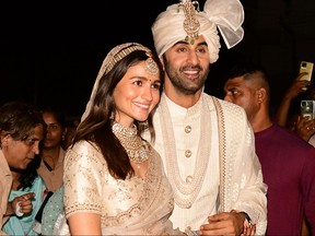 Bollywood actors Ranbir Kapoor, right, and Alia Bhatt pose for pictures during their wedding ceremony in Mumbai on April 14, 2022.