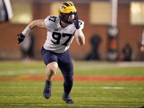 Michigan defensive end Aidan Hutchinson rushers in Maryland during the first half of an NCAA college football game, Saturday, Nov. 20, 2021, in College Park, Md.