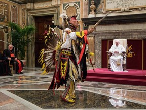 This photo taken and handout on April 01, 2022 shows a delegation member chant and dance before Pope Francis during an audience to Canada's Indigenous delegations at the Vatican.