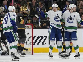 Canucks centre Elias Pettersson (second from right) celebrates after scoring one of his two goals on the night against the Vegas Golden Knights during their NHL game in Las Vegas last Wednesday.