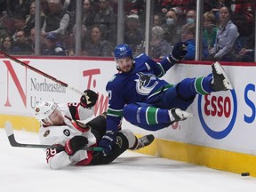 Ottawa Senators' Connor Brown, left, and Vancouver Canucks' Oliver Ekman-Larsson collide during the first period of an NHL hockey game in Vancouver, B.C., Tuesday, April 19, 2022.