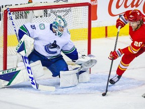 Vancouver Canucks goaltender Thatcher Demko (35) makes a save against Calgary Flames center Blake Coleman (20) during the first period at Scotiabank Saddledome.