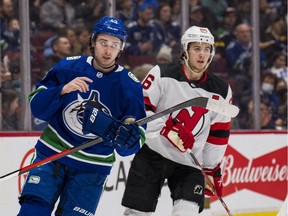 Canucks defenceman Quinn Hughes (left) and his younger brother, New Jersey Devils centre Jack Hughes, during a March 2022 NHL game at Rogers Arena.