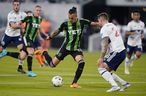 Austin FC forward Maxi Urruti (37) drives to score past Vancouver Whitecaps FC defender Jakob Nerwinski, front right, during the first half of an MLS soccer match, Saturday, April 23, 2022, in Austin, Texas.