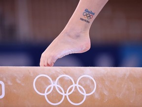 Tokyo 2020 Olympics - Gymnastics Artistic Training - Ariake Gymnastics Centre, Tokyo, Japan - July 22, 2021 Olympic tattoos are seen on a Canada gymnast on the balance beam during training