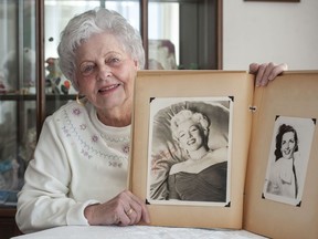 Joan Moore with her collection of autographed photos of movie stars from the 1950's, including Marilyn Monroe.