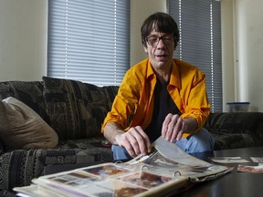 Allan Carrigan looks through an album of old photos at his Langley home on Tuesday. Carrigan has alleged that he was sexually abused as a 12-year-old boy in Kitimat in 1981.