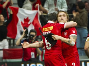 Canada's Jake Thiel is hugged by Alex Russell during their game against Scotland at the 2022 Canada Sevens at B.C. Place Stadium on April 17, 2022.