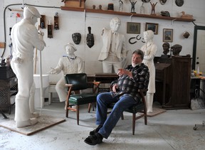 Sculptor Norm Williams in his studio in Abbotsford earlier this year. The original figures used to form the casts for his previous works, Steveston’s Legacy and Roger Neilson, can be seen behind him. Photo: Nick Procaylo