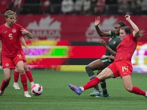 Canada's Vanessa Gilles, right, and Nigeria's Ifeoma Onumonu vie for the ball during the first half of a women's friendly soccer match, in Vancouver, on Friday, April 8, 2022.