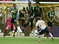 Austin FC defender Matt Besler (5) heads the ball after a shot by Vancouver Whitecaps FC midfielder Ryan Gauld (25) at B.C. Place on Sept. 4, 2021.