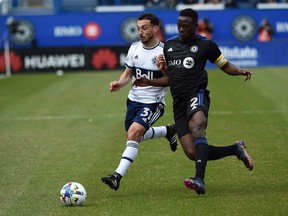 CF Montréal midfielder Victor Wanyama (2) fights for the ball against Vancouver Whitecaps midfielder Russell Teibert (31) during the first half at Stade Saputo.