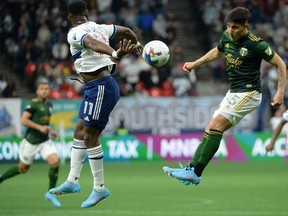 Vancouver Whitecaps forward Cristian Dajome and Portland Timbers defender Claudio Bravo jump for a header during the first half at B.C. Place Saturday.