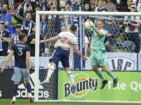 Sporting Kansas City goalkeeper Tim Melia  blocks a shot from Vancouver Whitecaps forward Brian White  during the first half at BC Place April 2, 2022.