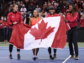 Canada's Rebecca Marino, from left to right, Leylah Annie Fernandez, captain Heidi El Tabakh and Francoise Abanda celebrate after Fernandez defeated Latvia's Daniela Vismane during a Billie Jean King Cup qualifier singles tennis match, in Vancouver, on Saturday.