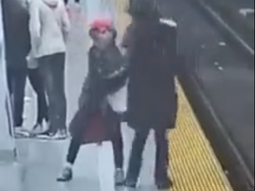 In this screengrab taken from video posted by BlogTO, a woman is shoved onto the subway tracks at Bloor-Yonge Station on Sunday, April 17, 2022. The victim survived.