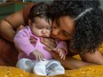 File photo: Arantza Laberdesque with her 2-month-old daughter, Oceane Lacasse at home in Longueuil on Wednesday May 4, 2022.