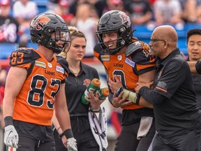 Lions quarterback Kevin Thomson is helped off the field in discomfort after being hit on a blitz by Calgary Stampeder Titus Wall in the final minutes of a 41-6 pre-season loss to the Stamps at McMahon Stadium on Saturday.