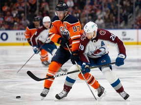 Edmonton Oiler Conor McDavid (left) battles for the puck against Nathan McKinnon of the Colorado Avalanche during a National Hockey League game in Edmonton last month.