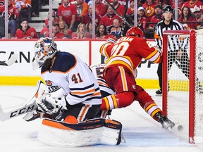 CALGARY, AB - MAY 26: Blake Coleman #20 of the Calgary Flames kicks the puck past Mike Smith #41 of the Edmonton Oilers resulting in a non-goal during the third period of Game Five of the Second Round of the 2022 Stanley Cup Playoffs at Scotiabank Saddledome on May 26, 2022 in Calgary, Alberta, Canada.