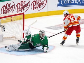 Johnny Gaudreau #13 of the Calgary Flames scores on a penalty shot against Jake Oettinger #29 of the Dallas Stars in the third period in Game Four of the First Round of the 2022 Stanley Cup Playoffs at American Airlines Center on May 09, 2022 in Dallas, Texas.