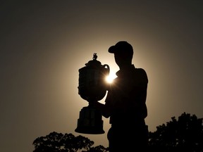 Justin Thomas of the United States poses with the Wanamaker Trophy after putting in to win on the 18th green, the third playoff hole during the final round of the 2022 PGA Championship at Southern Hills Country Club on May 22, 2022 in Tulsa, Oklahoma.