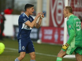 Whitecaps' Cristian Gutierrez celebrates his winning goal with the team's keeper Cody Cropper in penalty kicks during Canadian Championship quarter final soccer action between Cavalry FC and Vancouver Whitecaps at ATCO Field at Spruce Meadows in Calgary on Wednesday, May 25, 2022.