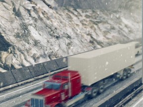 A truck on the Coquihalla in the snow.