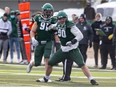 Huskies' defensive lineman Nathan Cherry (No. 90) celebrates a play as the University of Saskatchewan Huskies take on the Regina Rams at Griffiths Stadium.