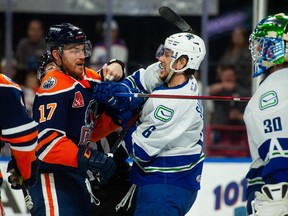 Abbotsford Canucks defenceman Ashton Sautner battles with Bakersfield Condors forward Brad Malone during Game 2 of their best-of-three opening round AHL playoff series.
