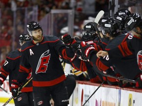 Jaccob Slavin of the Hurricanes celebrates with his team following his first period goal against the Bruins in Game 5 of the first round of the 2022 Stanley Cup Playoffs at PNC Arena in Raleigh, N.C., Tuesday, May 10, 2022.