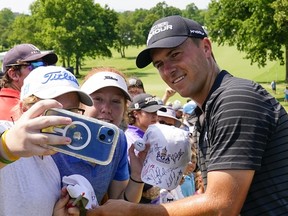 Jordan Spieth takes a selfie with a fan on Wednesday following a practice round for this PGA Championship, which begins Thursday at Southern Hills Country Club in Tulsa, Okla.