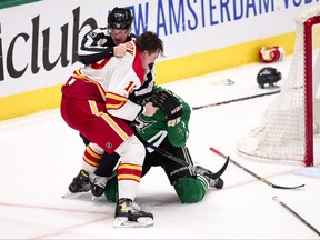 Nikita Zadorov of the Calgary Flames and Esa Lindell of the Dallas Stars fight during the third period in Game 6 of the First Round of the 2022 Stanley Cup Playoffs at American Airlines Center on May 13, 2022 in Dallas, Texas.