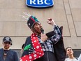 People, including Wet'suwet'en hereditary chief Na'moks, protest outside an RBC building in Montreal on May 12, 2022, due to its involvement in the Coastal GasLink pipeline project. RBC has become the focus for a number of acts of vandalism even though it is only one of 20 or so lenders to Coastal GasLink.